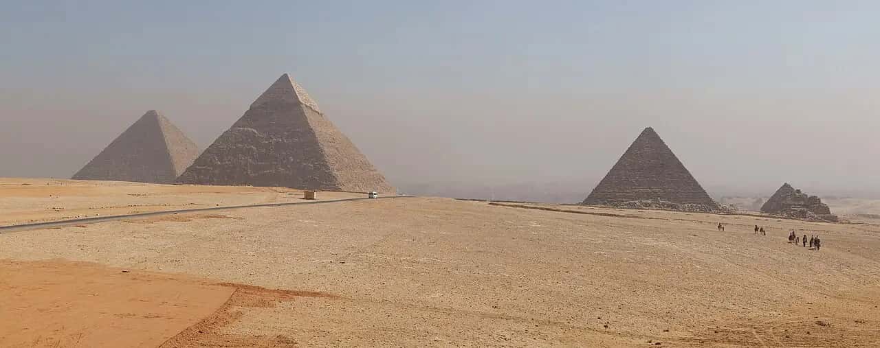 The pyramids of Giza across the desert in Egypt